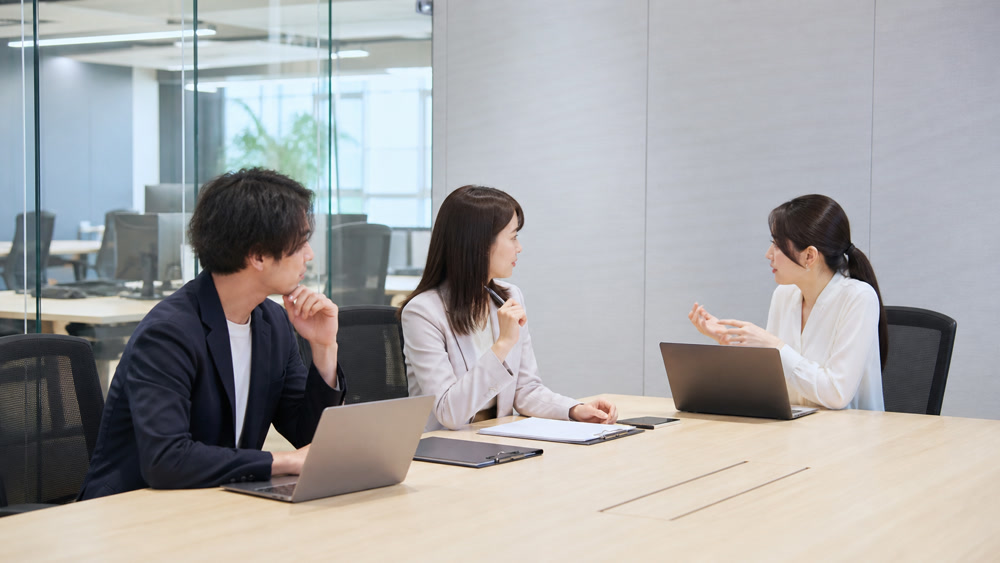 会社組織と事業部門の関係について会議室で話し合う一般的なイメージ