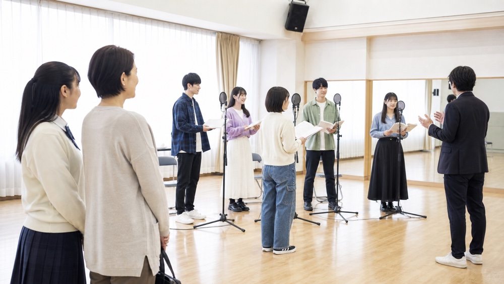 学校見学で声優学科の卒業公演リハーサルを観察する高校生と保護者